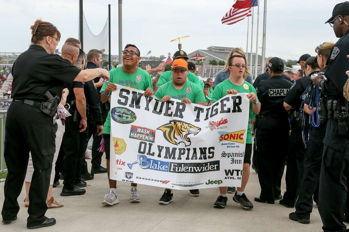 Participating teams with about 3,000 athletes and coaches walked through police officers at Toyota Field on Friday.