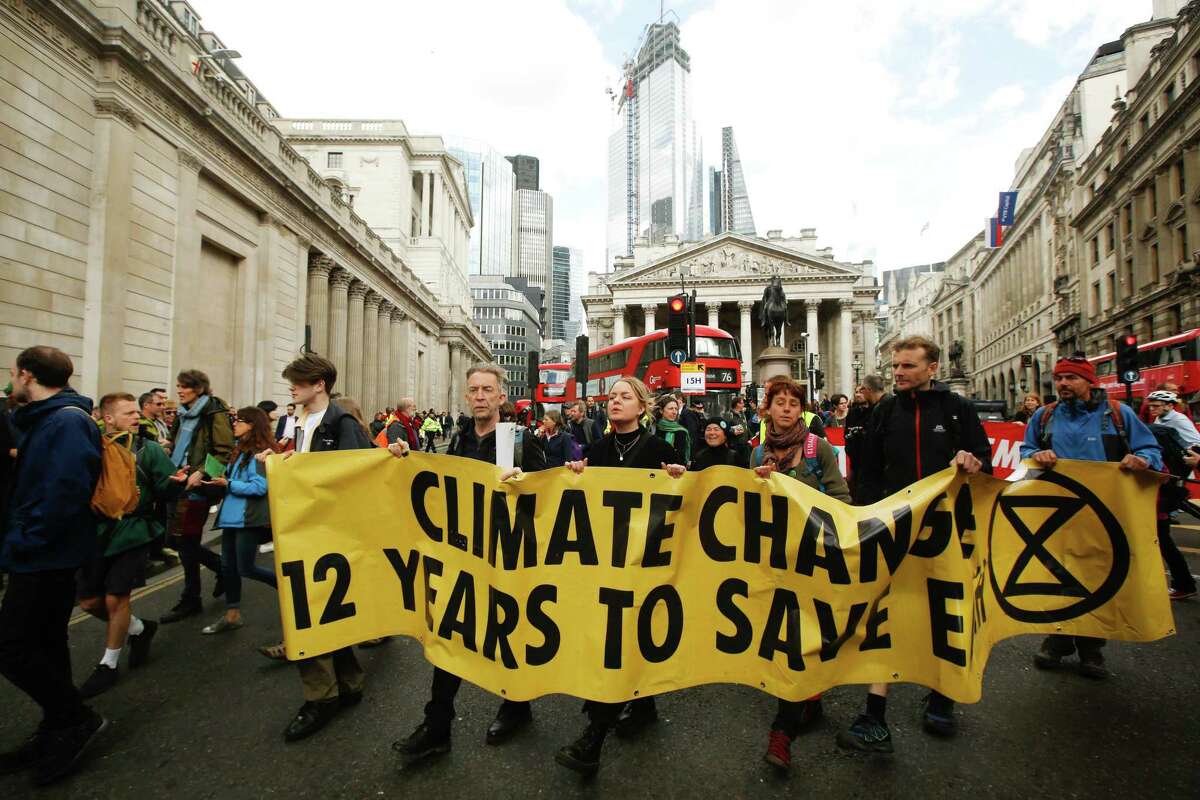 Climate activists from the Extinction Rebellion group demonstrate during protests outside the Bank of England in the City of London, U.K., on Thursday, April 25, 2019. The demonstrators are demanding that the U.K. acknowledge the "crisis" posed by global warming, enact legally binding policies to reduce net carbon emissions to zero by 2025, and form a citizens assembly to oversee changes. Photographer: Luke MacGregor/Bloomberg