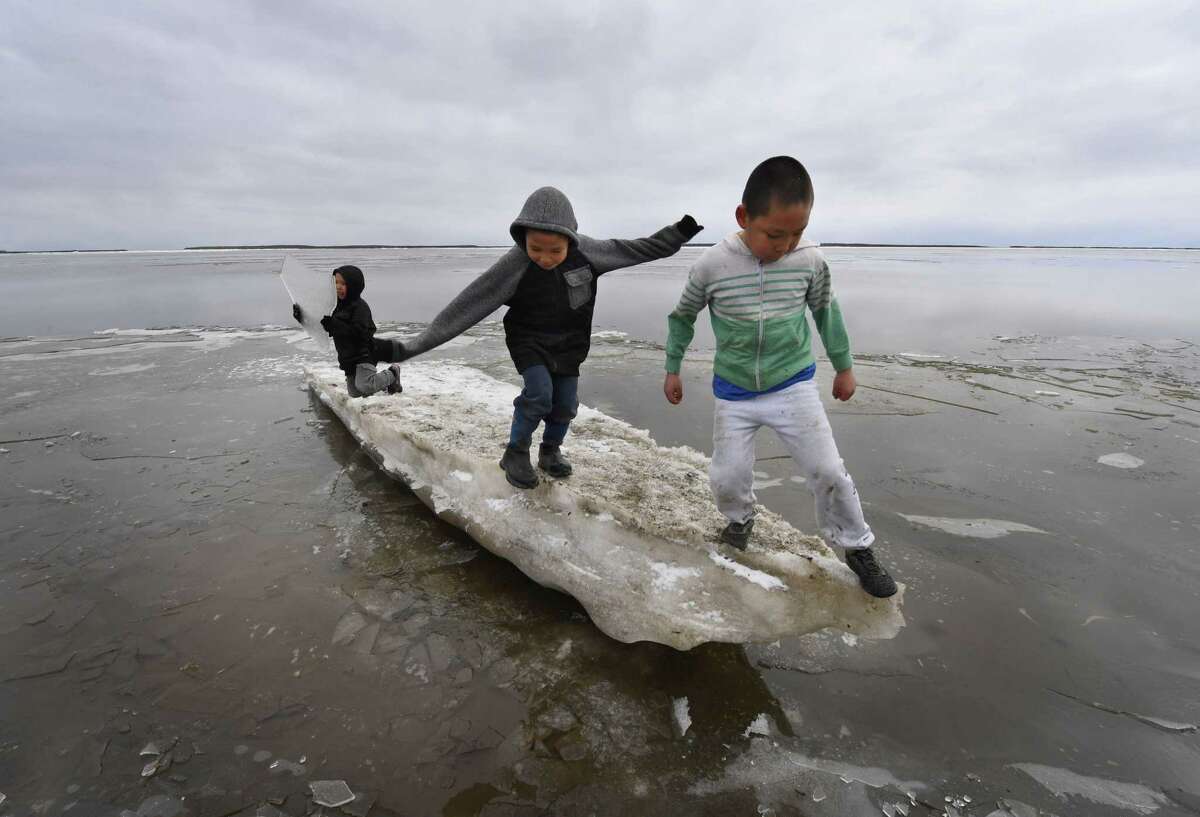 Schoolchildren play on melting ice at the climate change affected Yupik Eskimo village of Napakiak on the Yukon Delta in Alaska on April 18, 2019. With recent unusually high temperatures life in this remote villages has been affected causing eroded land, flooding, and difficulties to access roads and to hunting. (Photo by Mark RALSTON / AFP)MARK RALSTON/AFP/Getty Images