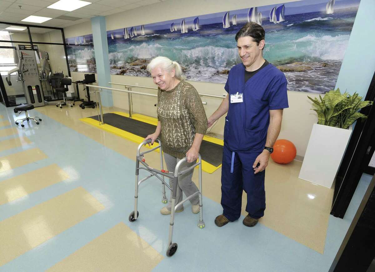Lucyna Syrek, a resident at Cassena Care nursing home in Stamford, works with physical therapist Michael Fine in 2016.