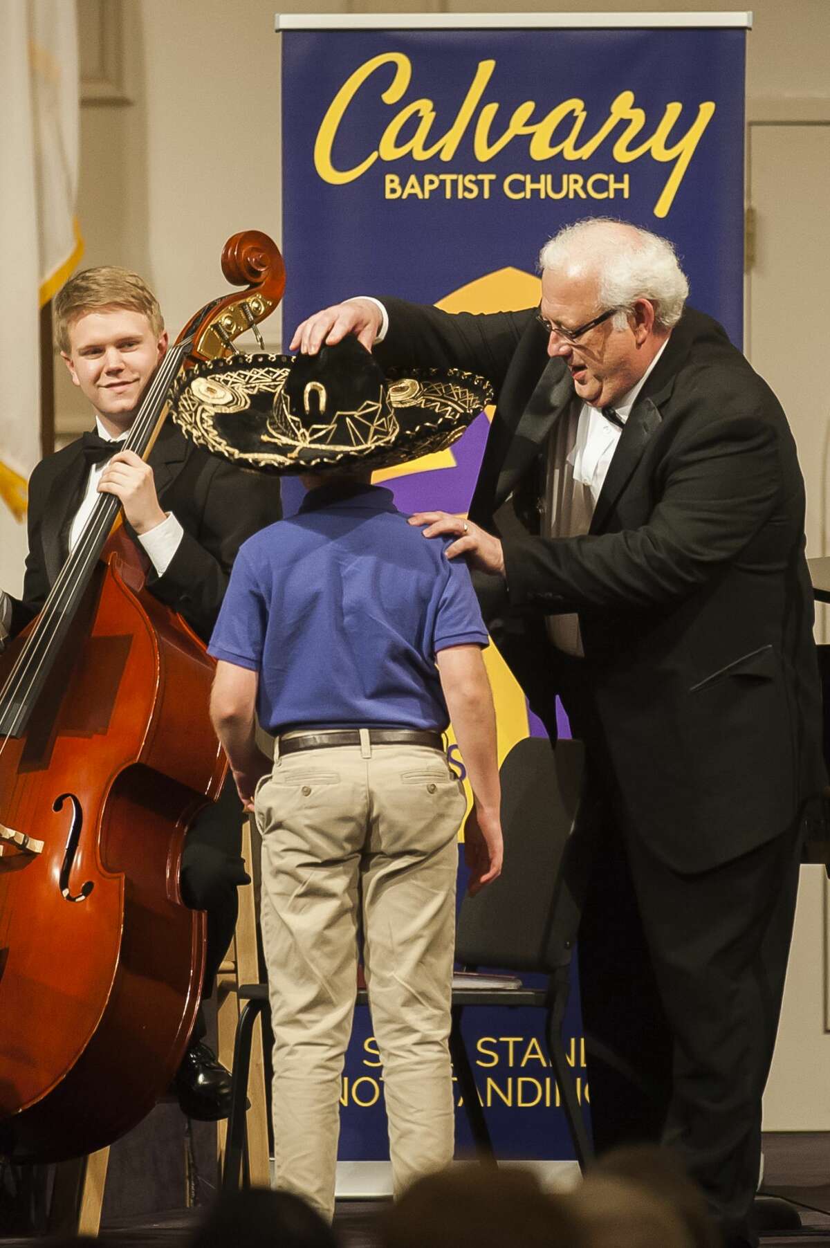 Calvary Baptist Academy Band Director Dr. Dana Everson places a sombrero on the head of a student during a spring concert on Thursday, May 2, 2019 at the school. Everson is retiring at the end of this school year. (Katy Kildee/kkildee@mdn.net)
