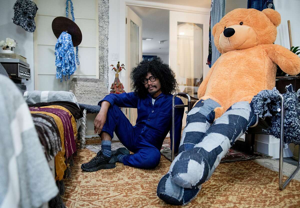 Textile artist Llane Alexis poses for a portrait among his finished and in-progress pieces inside his home and studio space in San Francisco, Calif., Saturday, April 27, 2019.