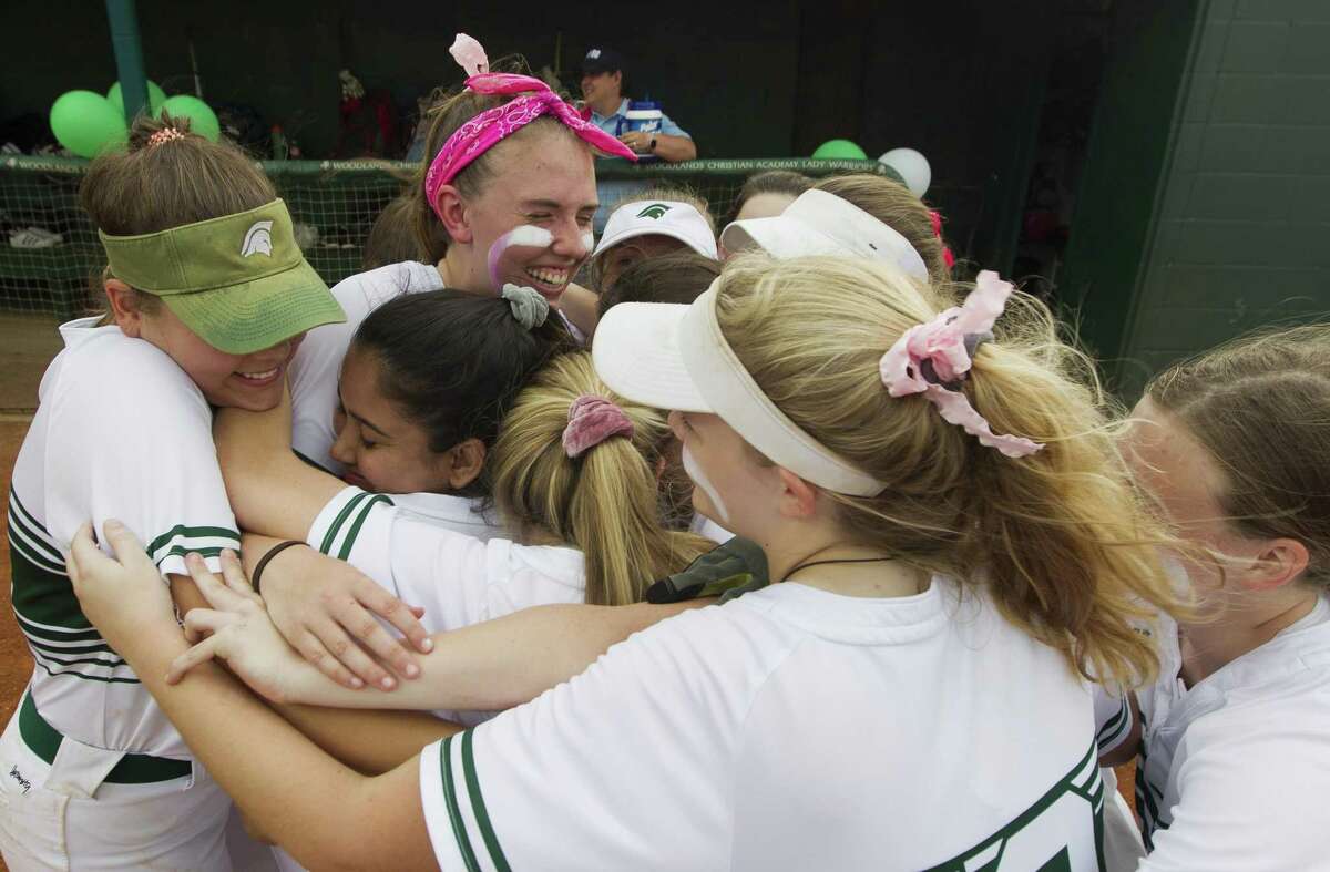 In this file photo, The Woodlands Christian Academy starting pitcher Faith Hanshaw, pink headband, gets group hug from teammates before her final home softball game, Tuesday, April 30, 2019, in The Woodlands.