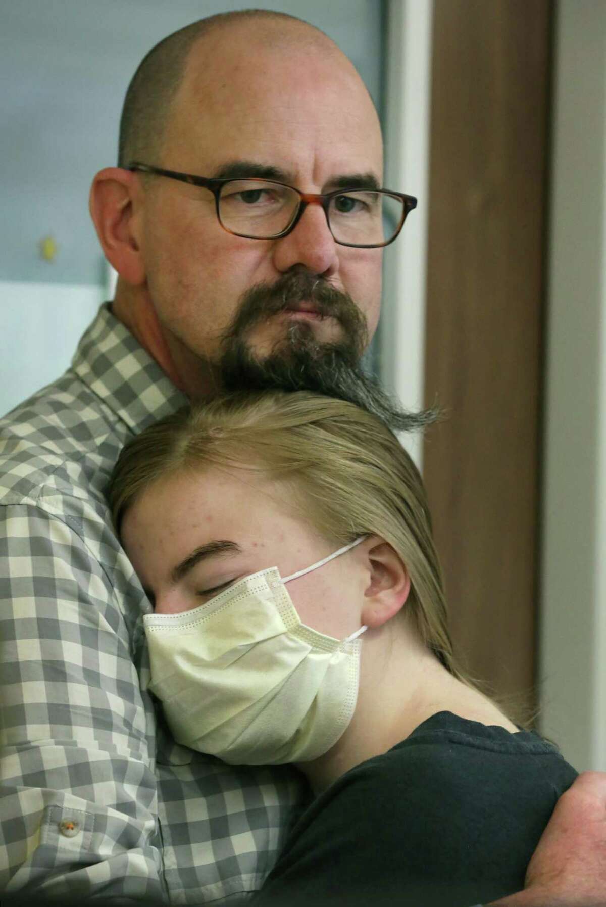 Ava Shepperd, 14, rests her head on the shoulder of her father, John Shepperd, during interviews May 6, 2019, at the University Transplant Center, where she and her brother John Ben Shepperd, who both have a genetic disorder that compromised their kidneys, were recipients of kidneys from one donor. The transplants took place May 3.