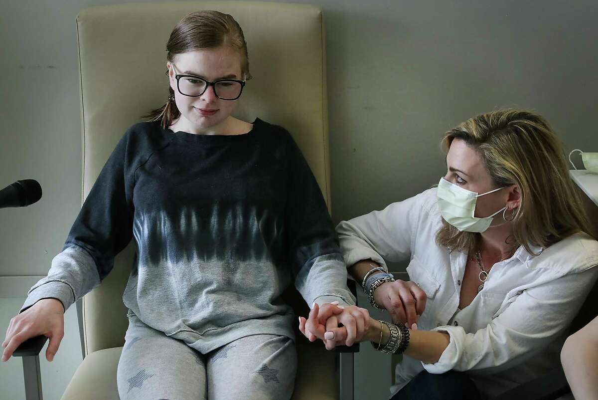 Ava Shepperd, 14, left, is interviewed as her mother, Kim Azar Shepperd, right, listens in her room at University Transplant Center on May 6, 2019. Ava and her brother, John Ben Shepperd, 18, who both have a genetic disorder that compromised their kidneys, were recipients of kidneys from one donor.