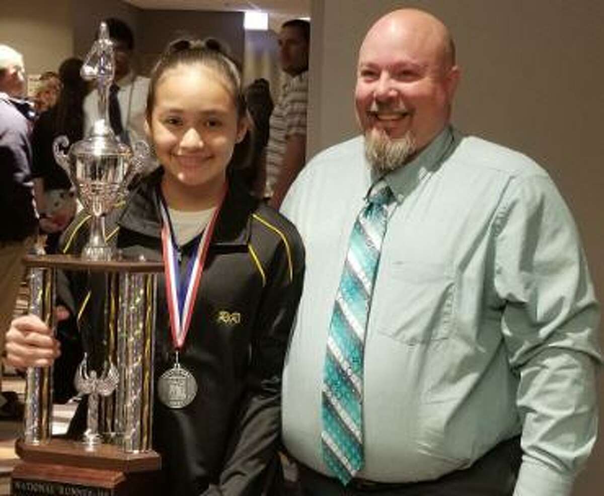 Rihanna DeLeon of Tays Junior High earned second place in the National Elks Hoop Shoot Free Throw competition. With her is William Sample, Katy Elks Hoop Shoot chairman. Katy Elks Lodge 2628 sponsored DeLeon.