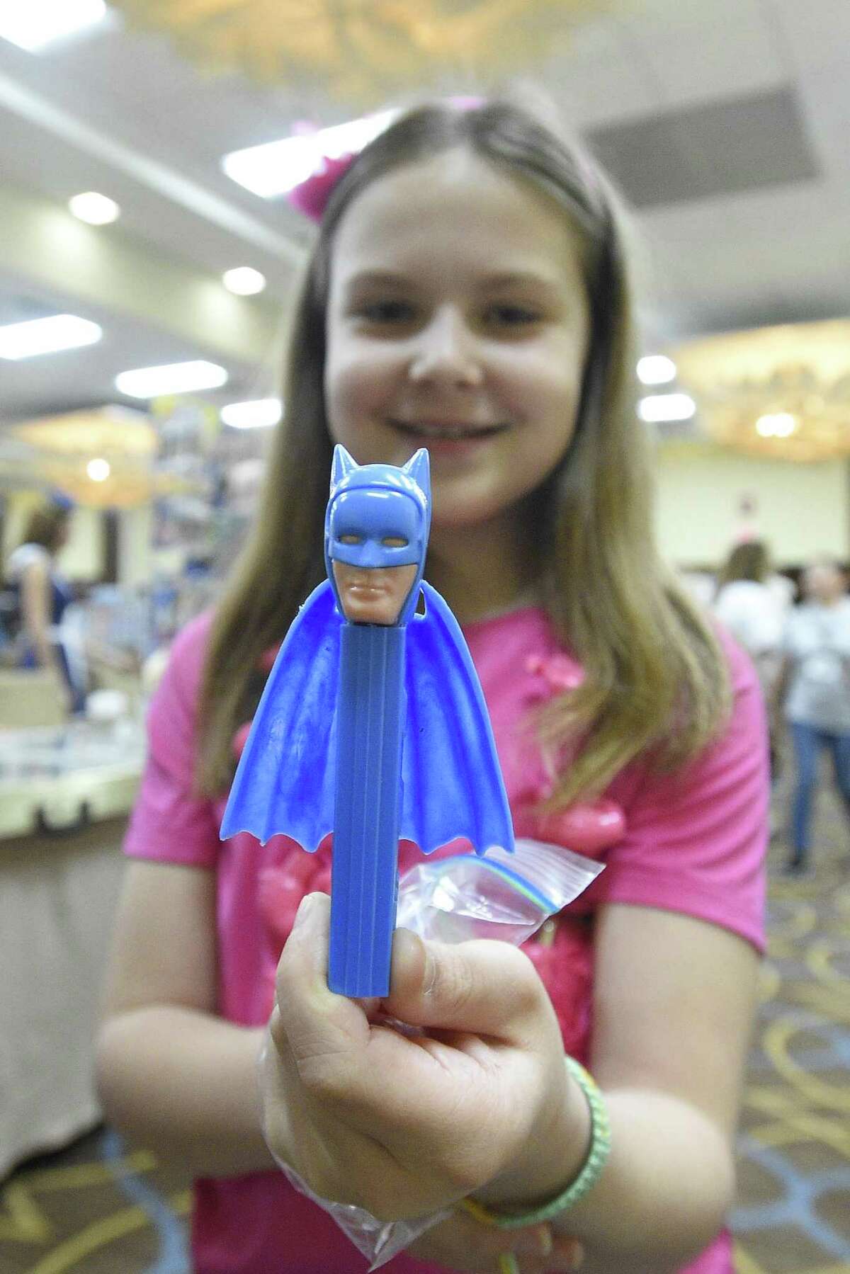Right, 11-year-old Veronica Sinnott of Albany, NY holds a rare Batman with Blue Cape PEZ candy dispenser her family purchased.