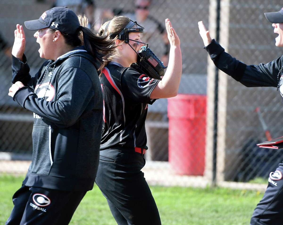 Cheshire’s Bri Pearson is congratulated by coaches in the fourth inning on her way to a no-hitter against Amity on Tuesday.