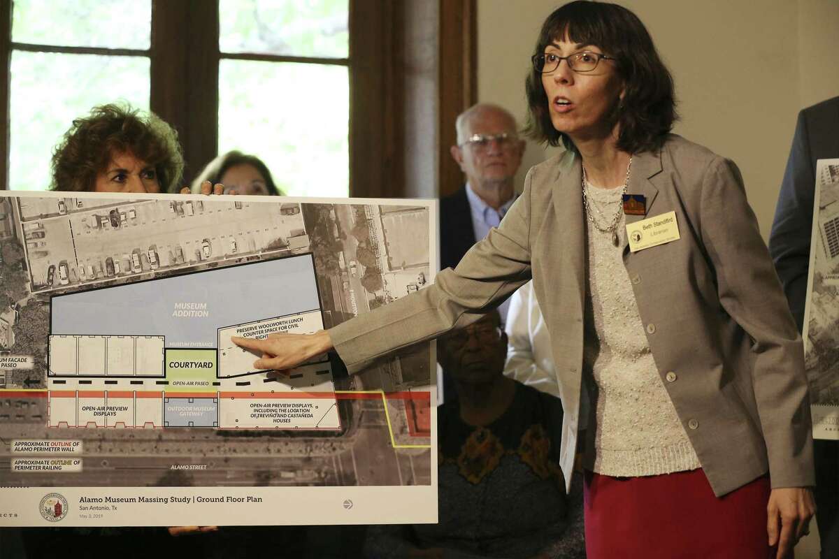 Beth Standifird, librarian with the San Antonio Conservation Society, points to a spot on a rendering which is believed to have been the location of the Woolworth's lunch counter as officials with the San Antonio Conservation Society unveil a “compromise plan” for Alamo Plaza.