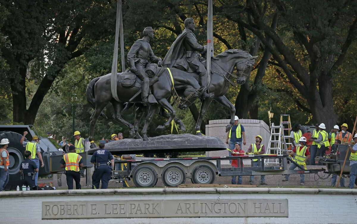 In this Sept. 14, 2017 file photo, the Robert E. Lee statue is put in the back of a trailer truck at Robert E. Lee Park in Dallas. The granite base that supported the now-removed statue of Robert E. Lee in the Dallas park and the seating and stairs surrounding it will be disassembled and stored. The city of Dallas said the work, which will cost $210,000, began Tuesday, Jan. 22, 2019. (Jae S. Lee/The Dallas Morning News via AP, File)