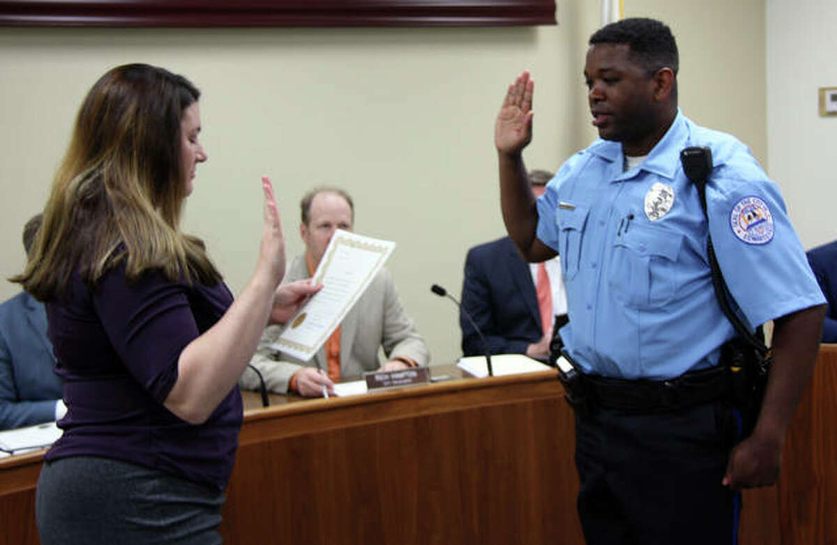Edwardsville City Clerk Jeannie Wojcieszak, left, administers the oath of office Monday to new Edwardsville Police Department Officer Silas Ellis, who is an Edwardsville resident.