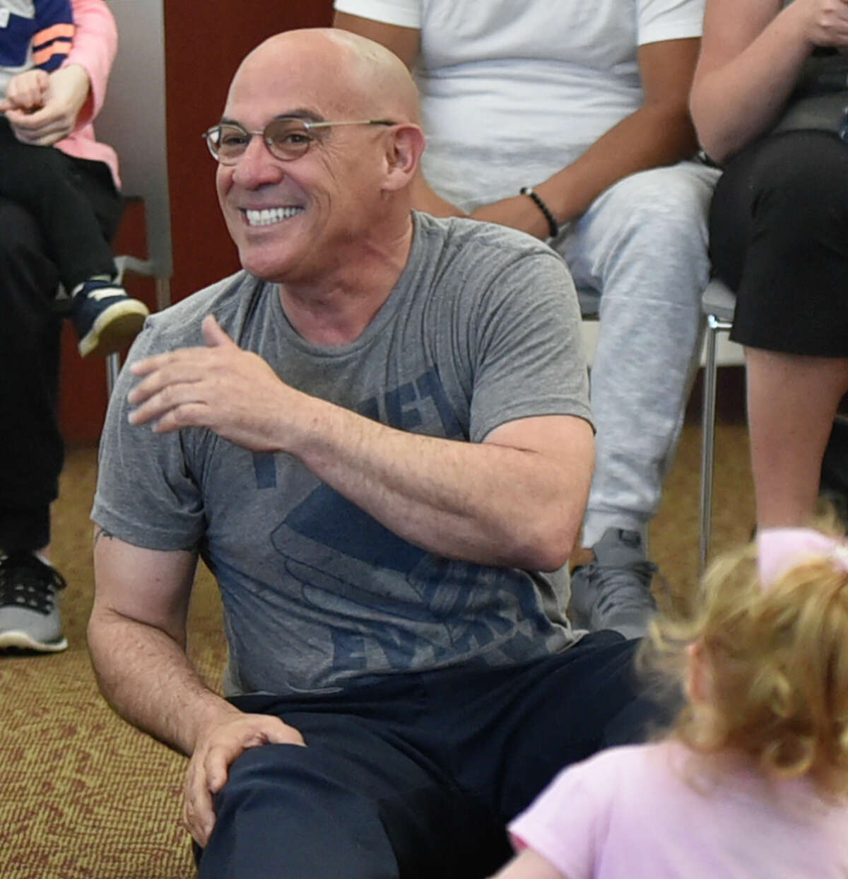 North Haven, Connecticut - Wednesday, May 8, 2019: Librarian Joe "Coach Joe" DeFrancesco leads the "Kids Rock" program Wednesday morning for children 6-months to 5 and their parents engaging them in music, movement, songs, and children's book stories at the North Haven Memorial Library.