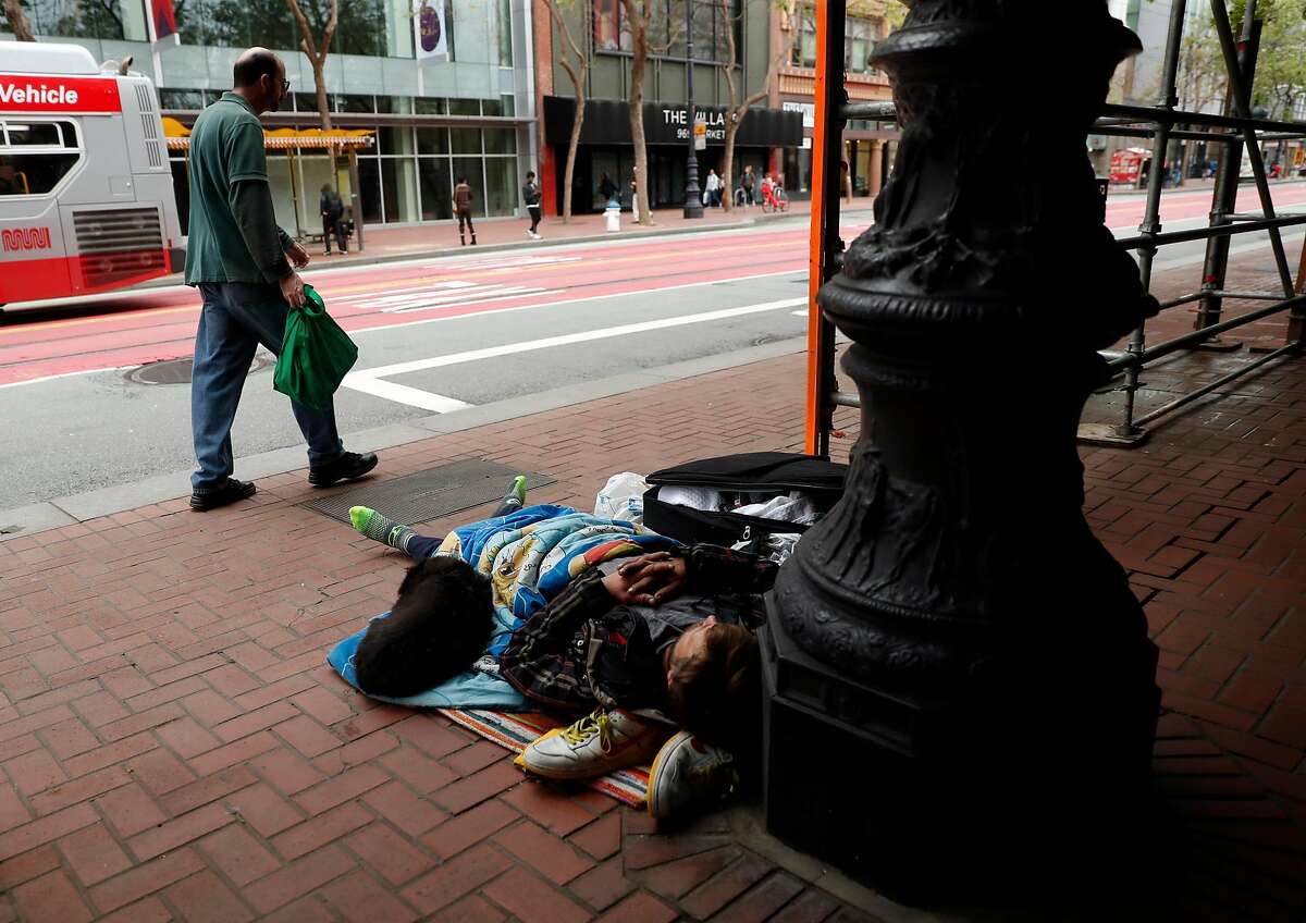 A man sleeps on Market Street in San Francisco, Calif., on Wednesday, April 3, 2019. Residents had lots of feelings about homelessness in the most recent biennial city survey.