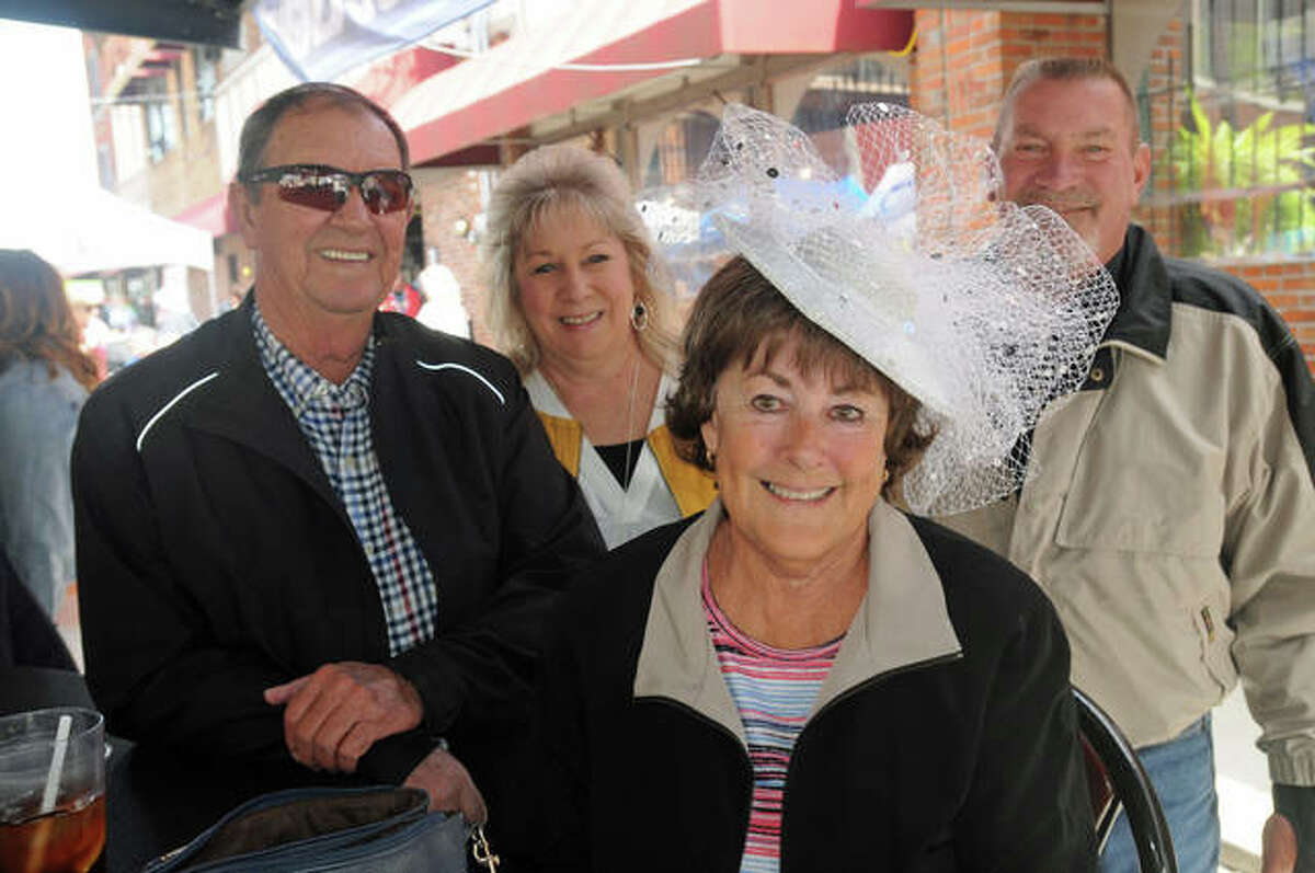 Nancy Brown of Alton is surrounded by her friends as she shows off her Derby hat at Mac’s on Saturday.