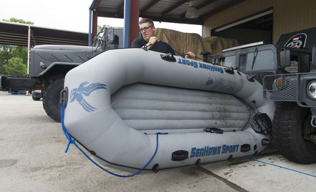 Cpt. Buck Clendennen with Montgomery County Precinct 4 Constable?•s Office moves an inflatable raft to be washed out after being used for water rescues the night before, Wednesday, May 8, 2019, in New Caney.