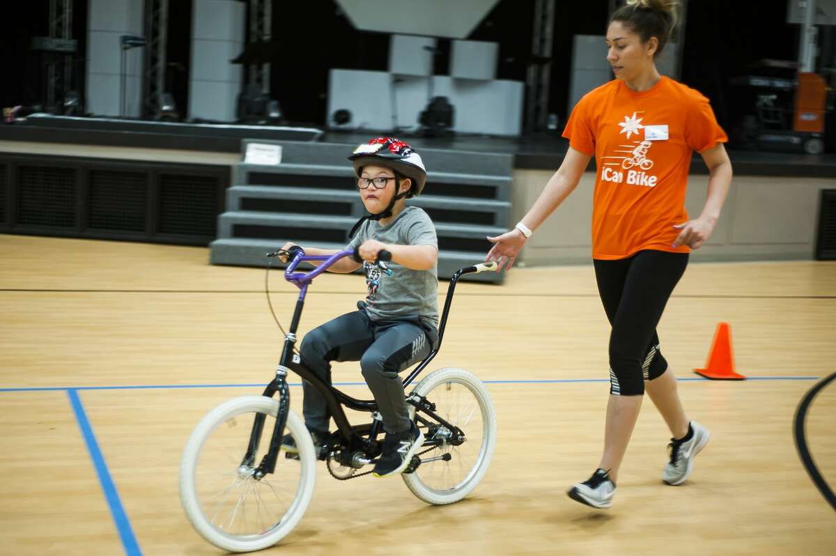 Jayson Brooks of Coleman, 10, mimics the sound of an engine while riding a bicycle for the first time after participating in the iCan Bike Camp, hosted by The Arc of Midland, on Wednesday, May 8, 2019 at Midland Evangelical Free Church. (Katy Kildee/kkildee@mdn.net)