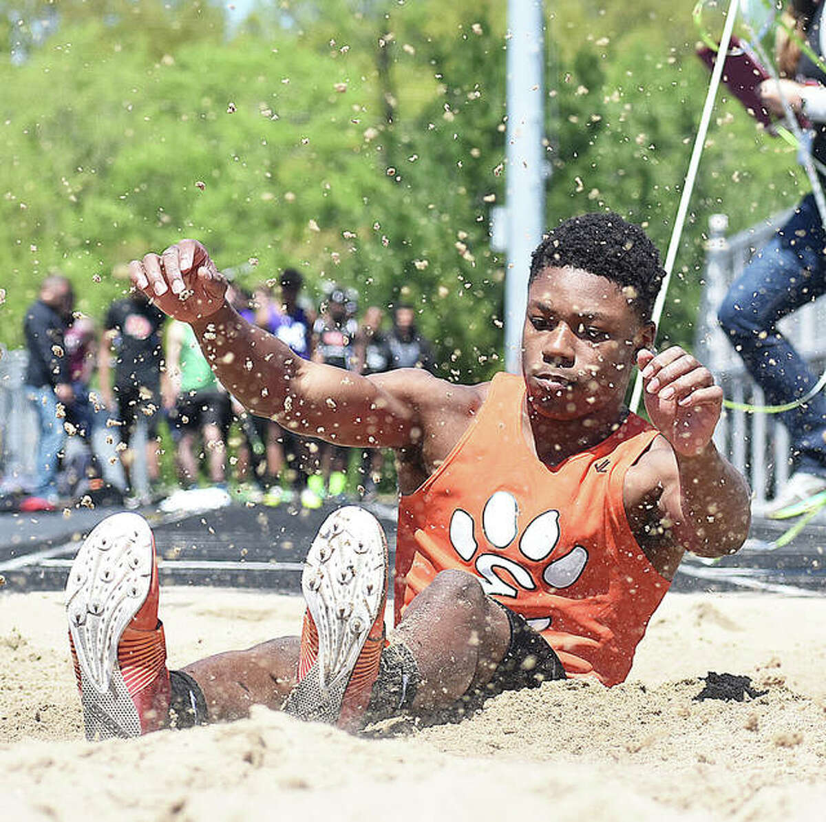 Edwardsville’s Kenyon Johnson completes a long jump during the Triad Invitational earlier in the season in Troy. Johnson broke the school record Wednesday in Collinsville.