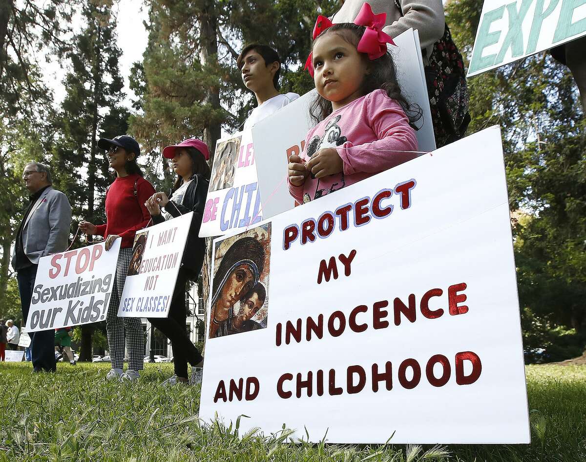 Angelie Reyes, 4, joins her family from Anaheim Hills to protest proposed changes to sex education guidance for teachers, Wednesday, May 8, 2019, in Sacramento, Calif. The California State Board of Education is set to vote Wednesday on new guidance for teaching sex education in public schools. The guidance is not mandatory but it gives teachers ideas about how to teach a wide range of health topic including speaking to children about gender identity. (AP Photo/Rich Pedroncelli)
