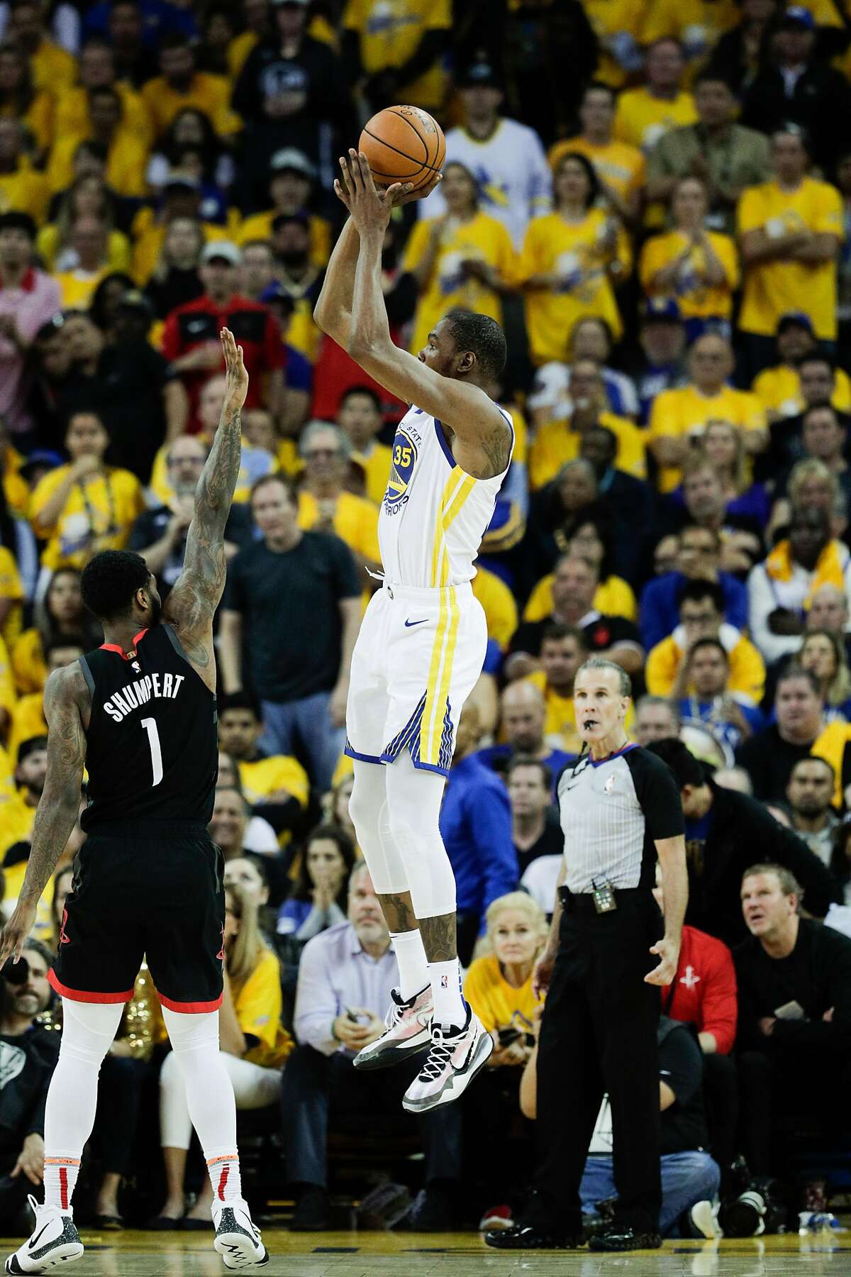 Golden State Warriors Kevin Durant shoots over Houston Rockets Iman Shumpert in the third quarter during game 5 of the Western Conference Semifinals between the Golden State Warriors and the Houston Rockets at Oracle Arena on Wednesday, May 8, 2019 in Oakland, Calif.