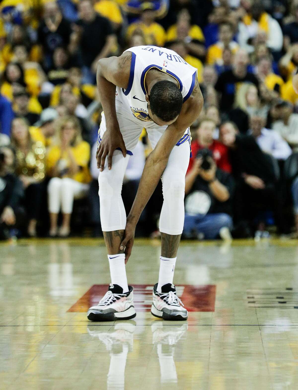 Golden State Warriors Kevin Durant checks his leg in the third quarter during game 5 of the Western Conference Semifinals between the Golden State Warriors and the Houston Rockets at Oracle Arena on Wednesday, May 8, 2019 in Oakland, Calif.