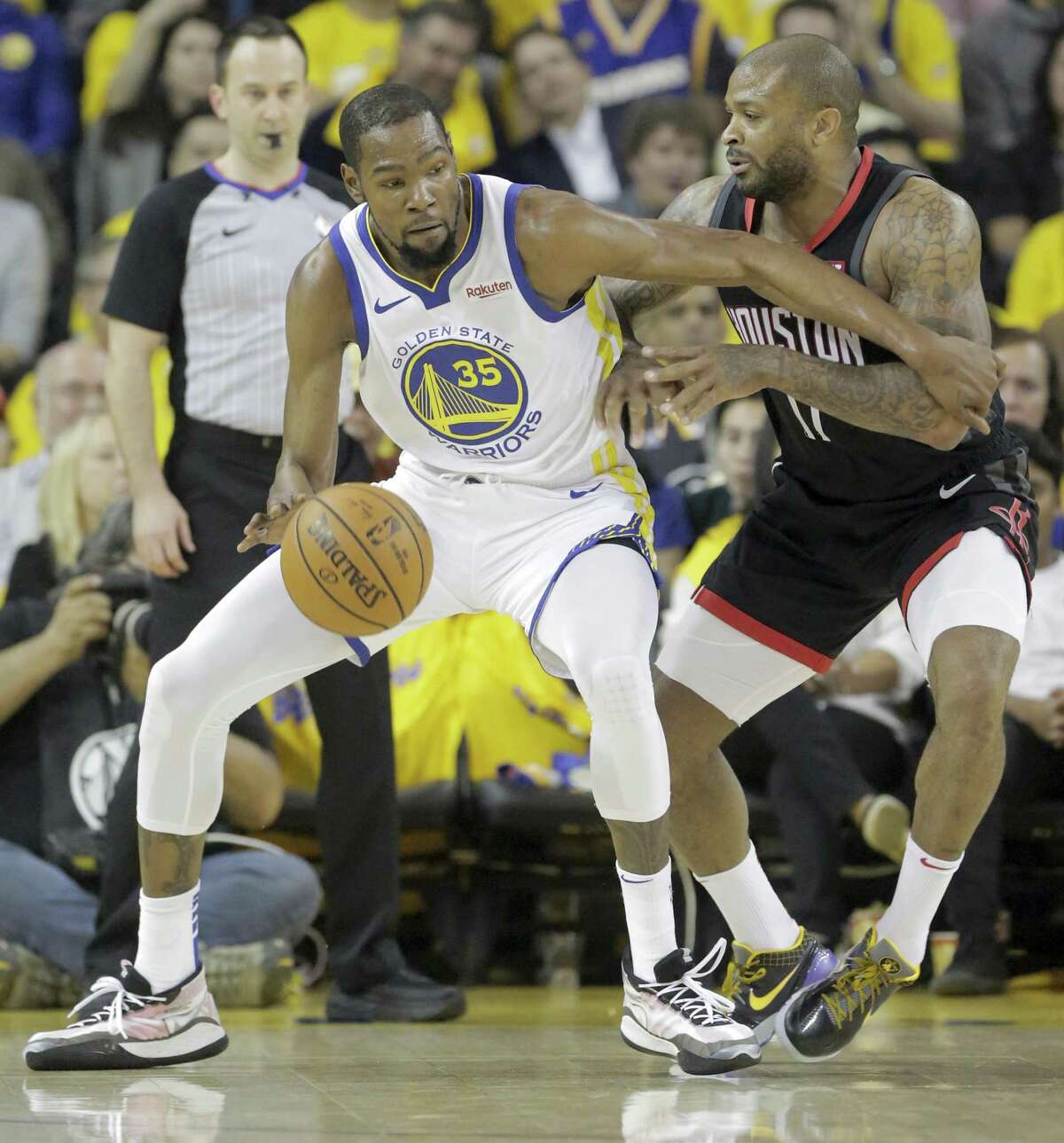 Golden State Warriors forward Kevin Durant (35) works the ball against Houston Rockets forward PJ Tucker (17) during the first half of Game 5 of the NBA Western Conference semifinals at Oracle Arena on Wednesday, May 8, 2019, in Oakland.