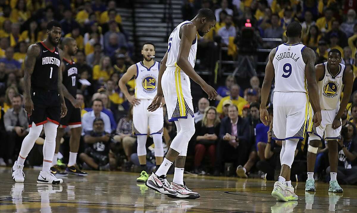 Golden State Warriors' Kevin Durant, center, limps off the court during the second half of Game 5 of the team's second-round NBA basketball playoff series against the Houston Rockets on Wednesday, May 8, 2019, in Oakland, Calif. (AP Photo/Ben Margot)