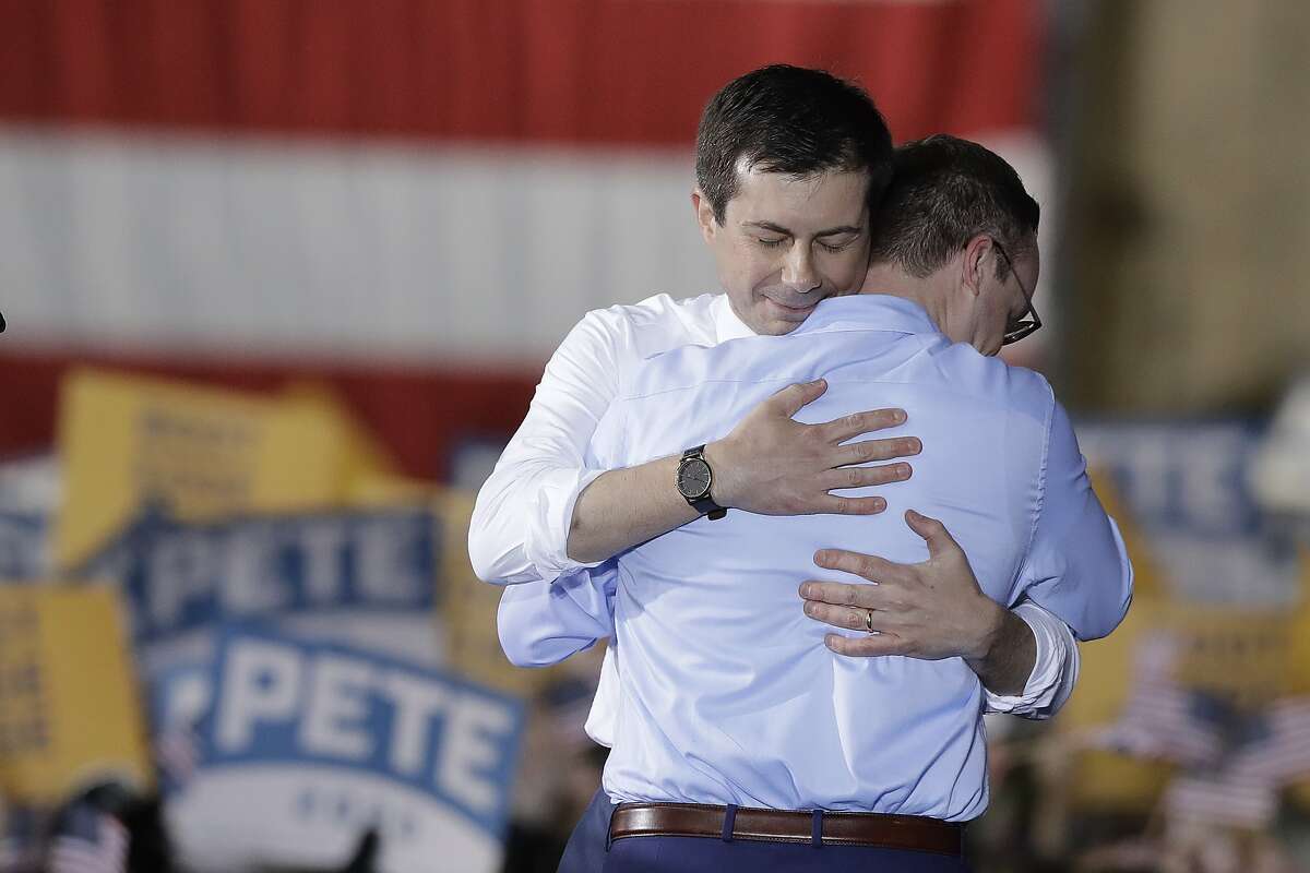 South Bend Mayor Pete Buttigieg, left, hugs his husband, Chasten Glezman, after Buttigieg announces that he will seek the Democratic presidential nomination during a rally, Sunday, April 14, 2019, in South Bend, Ind. (AP Photo/Darron Cummings)