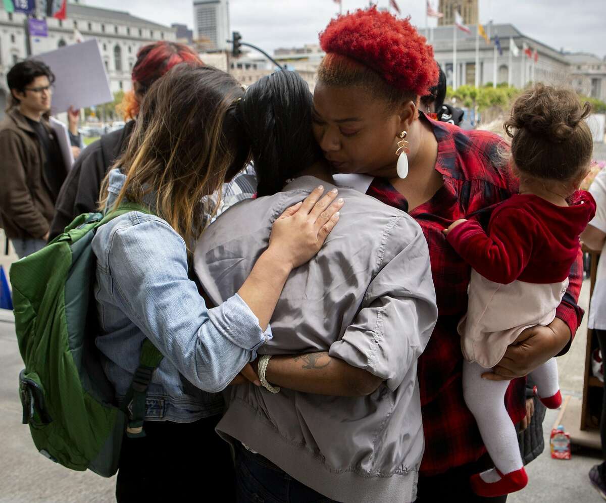 From left: Sam Lew, Sophia Thibodeaux, Danielle Kinnard and her Jeneila Kinnard, age 1, embrace outside City Hall during a protest on Thursday, May 9, 2019, in San Francisco, Calif. Homeless mothers and their supporters rallied to demand the city for housing subsidies, navigation centers and shelter funding for homeless families. Lew is the policy director for the Coalition on Homelessness. Thibodeaux has been homeless for four years. The Kinnard�s along with her other three-year-old son are staying at a shelter for families.