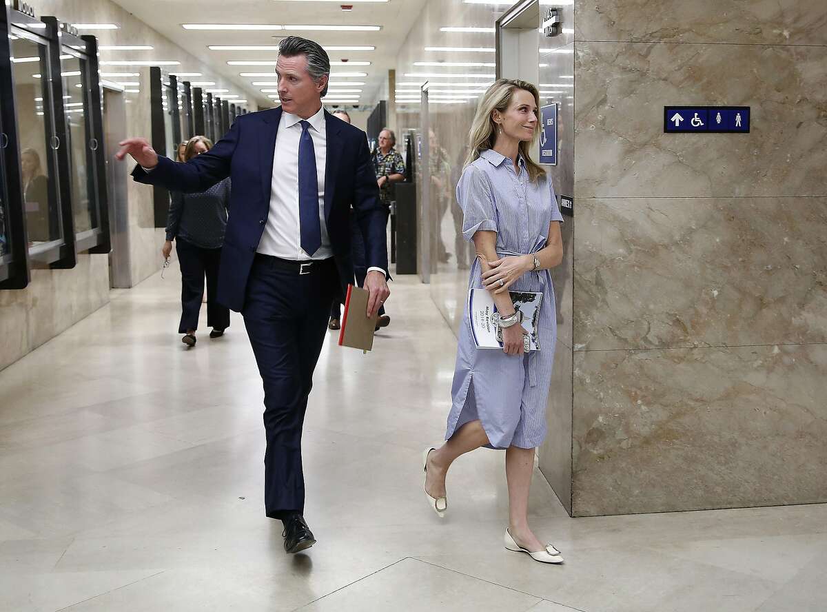 Gov. Gavin Newsom and his wife, First Partner Jennifer Siebel Newsom, return to the Governor's Office after he unveiled his revised 2019-2020 state budget at a news conference Thursday, May 9, 2019, in Sacramento, Calif. Newsom, a Democrat, has proposed a $213.5 billion spending plan. (AP Photo/Rich Pedroncelli)