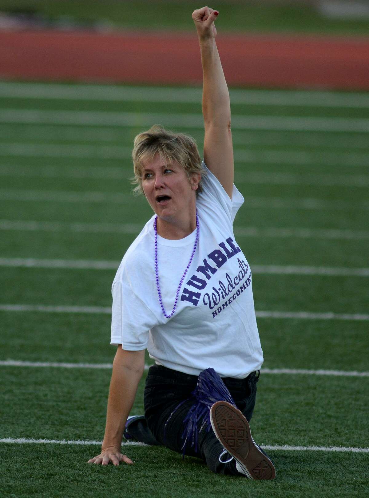 Humble High School Principal Donna Ullrich shows off her flexibility during a staff cheer at the HHS Homecoming Community Pep Rally in Turner Stadium on Sept. 14, 2016. (Photo by Jerry Baker/Freelance)