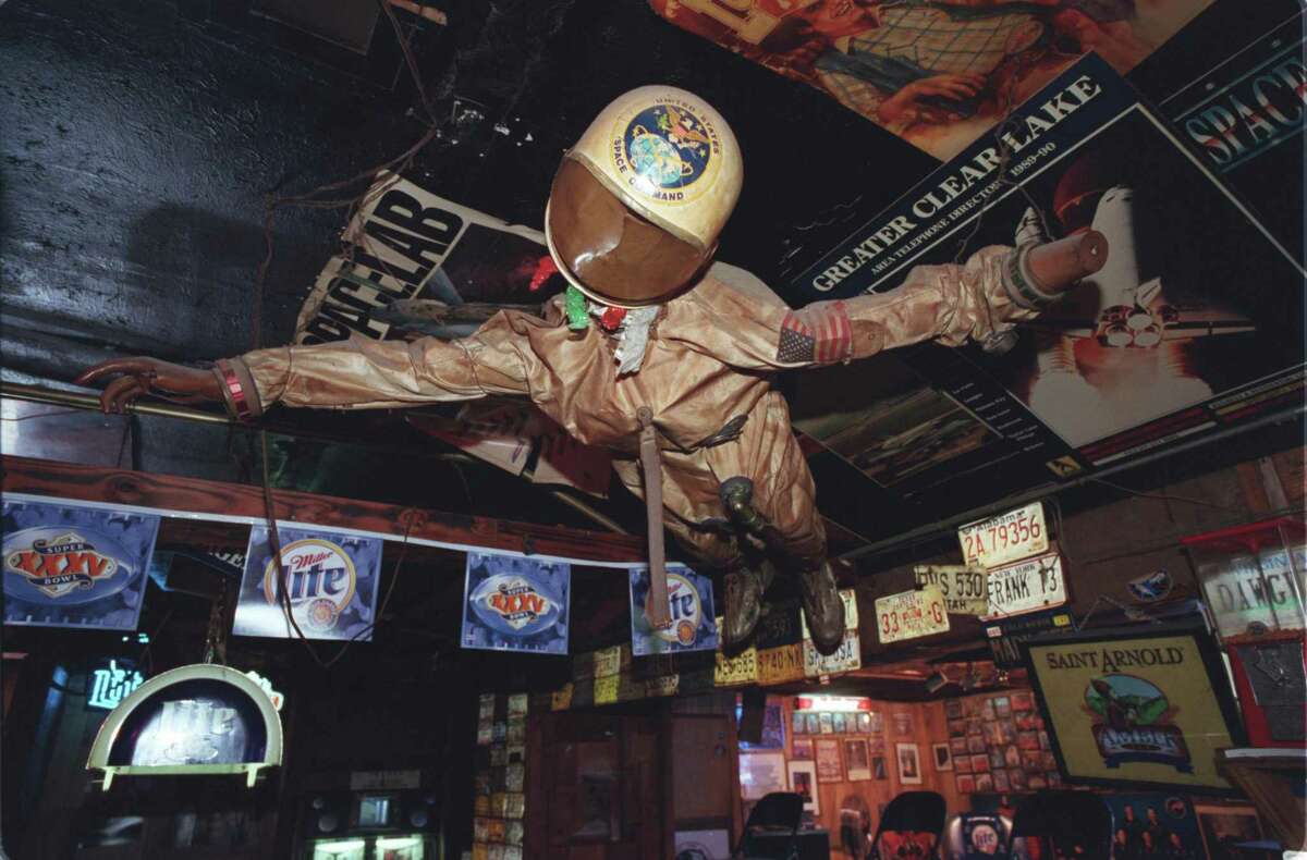 The Outpost Tavern, a legendary bar near NASA, closed in 2009 but the owners still have much of the old memorabilia and maintain hopes it could be reopened someday. Here, a flight suit and other space-related items decorate the Outpost.
