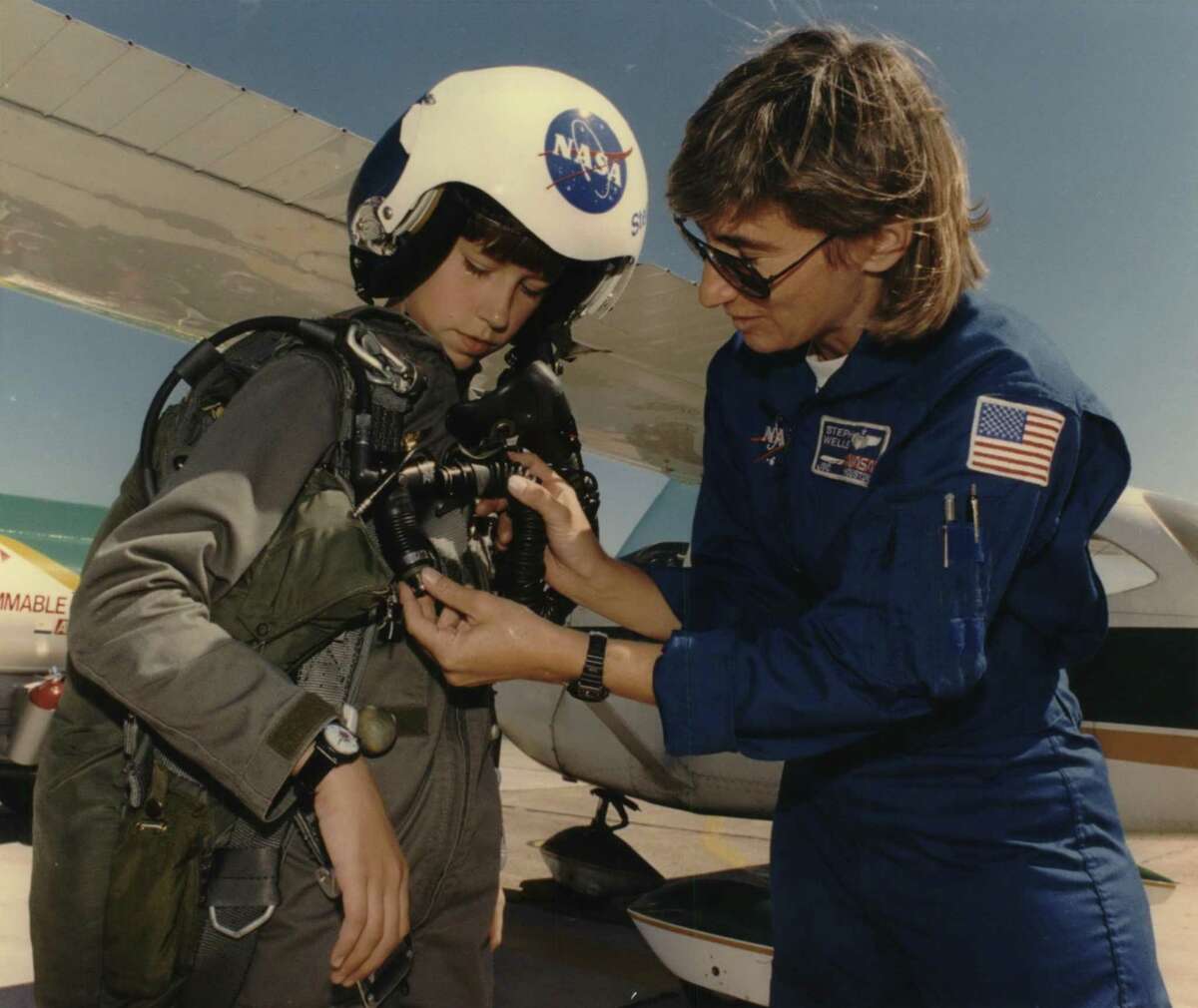 In this 1993 photo from the Houston Post archives, eleven-year-old Victoria Van Meter had one more milestone to complete after finishing her record-setting flight across the country on Sept. 23, 1993. Flying her plane to Houston's Ellington Field she was greeted by NASA pilot Stephanie Wells (R), who let her try on her flight helmet and parachute before touring Johnson Space Center. Van Meter dreamed of becoming an astronaut when she grew up. She died in 2008 at age 26.