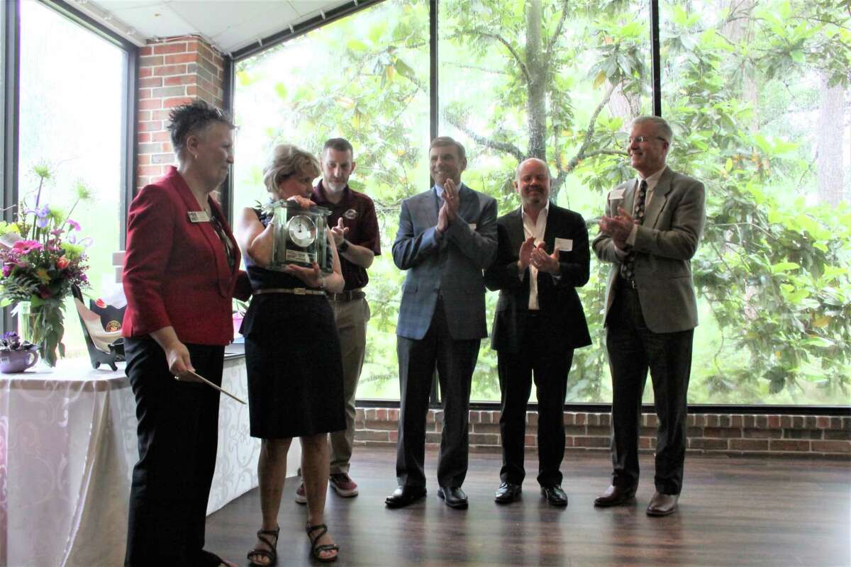 The Houston Northwest Chamber board members present a clock to its retiring president Barbara Thomason during a luncheon on Thursday, May 9, 2019.