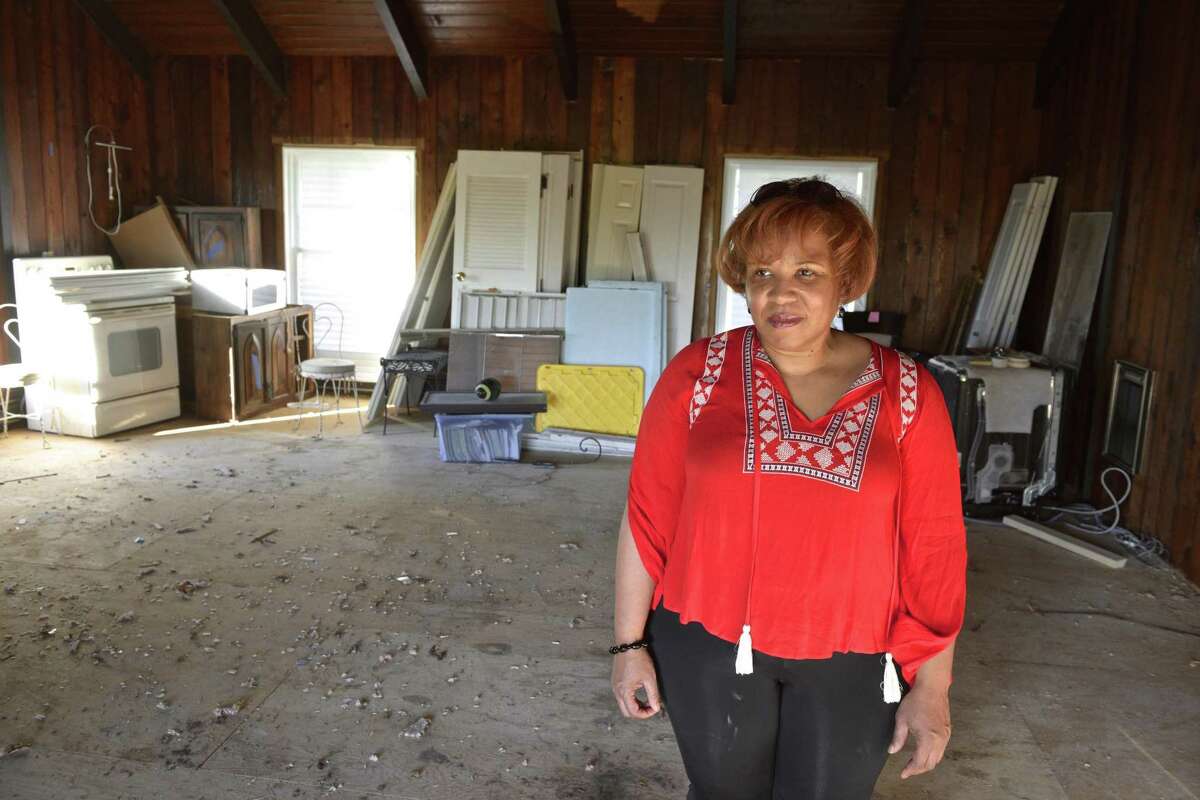 Gina Adams stands in her Brookfield home on Wednesday, nearly a year after a macroburst knocked out power and and devastated houses and properties across the Danbury area.