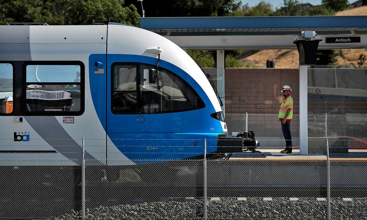 A BART worker waves to the operator of the new diesel-powered train as it departs the Antioch Station during a test run of a new BART extension that runs from the Pittsburg-Bay Point station to Hillcrest Avenue in Antioch, Calif., on Wednesday, May 23, 2018. The new people moving line runs down the middle of Highway 4 for that length