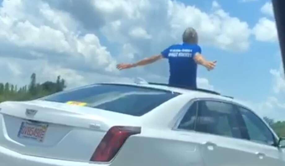 Video captures Florida man standing, resting against sunroof while