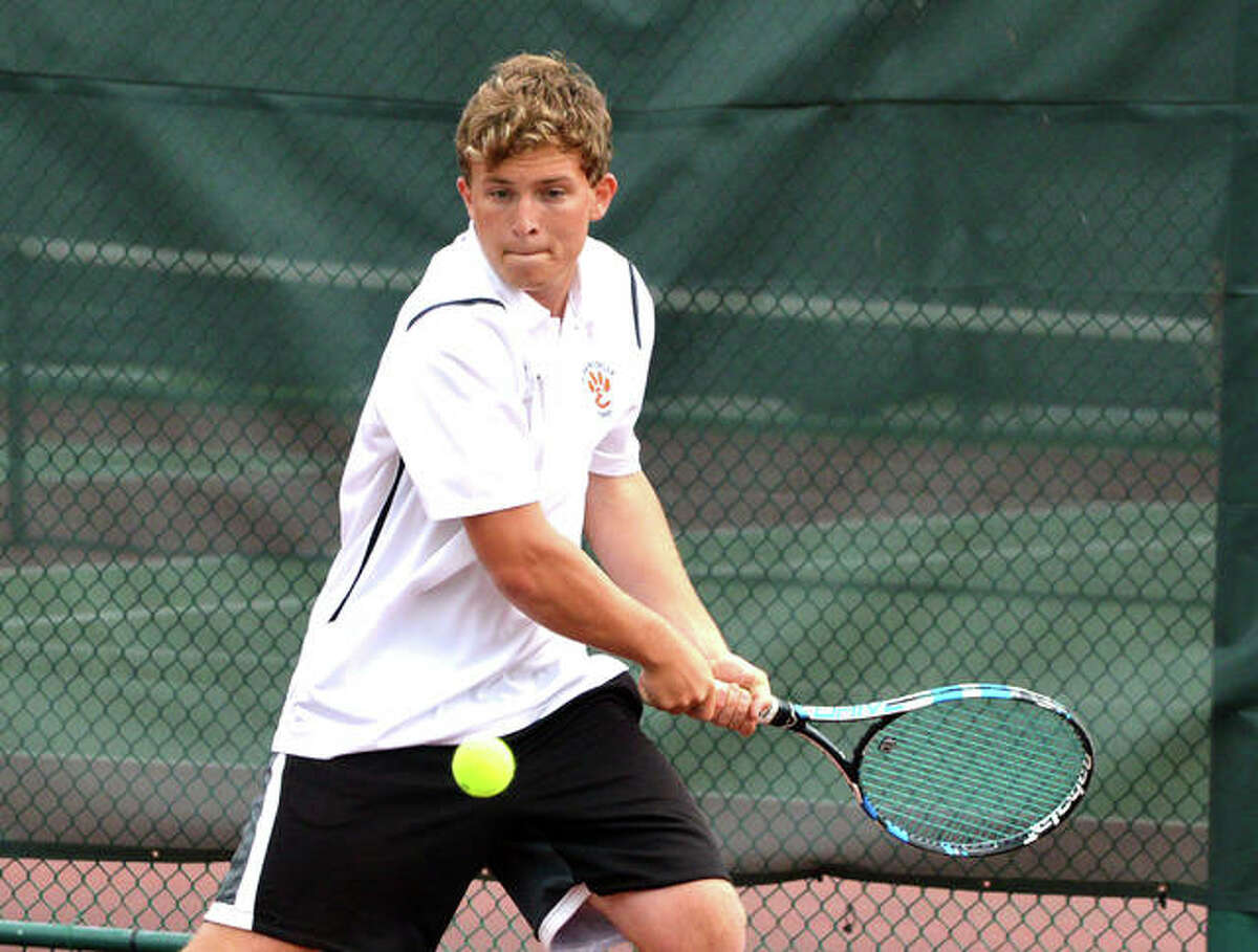 Edwardsville’s Nick Hobin makes a two-handed backhand return against Belleville East in the No. 3 doubles final in the Southwestern Conference Tournament Friday at Belleville West.