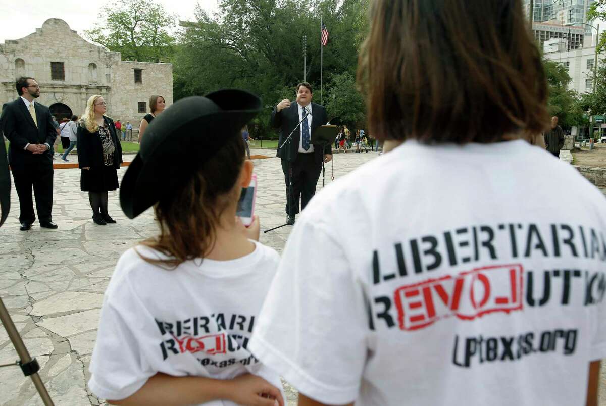 Libertarian party candidate for Texas lieutenant governor Robert Butler, at microphone, speaks in 2014 in front of the Alamo about his election platform during a news conference for Libertarian party candidates seeking statewide office.