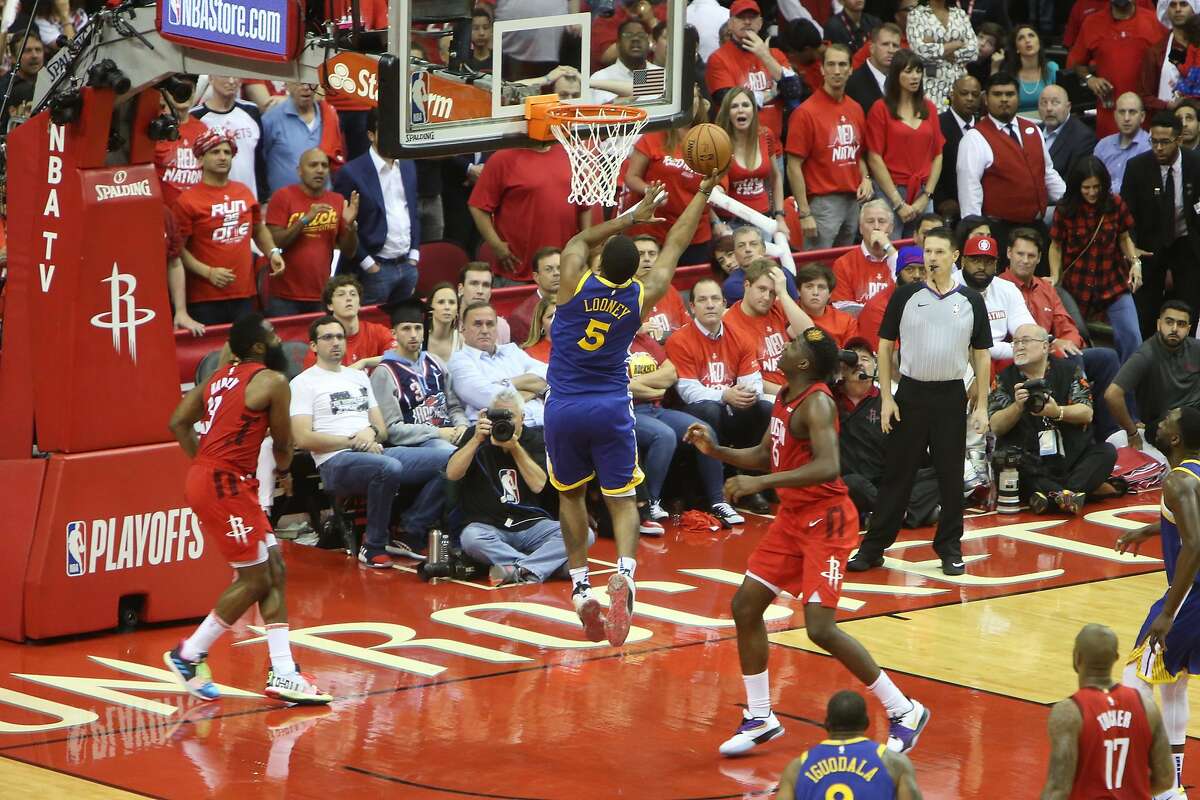 Golden State Warriors forward Kevon Looney attempts a layup between Houston Rockets guard James Harden and center Clint Capela in the 4th quarter during Game 6 in the Western Conference Semifinals against the Houston Rockets at Toyota Center in Houston, TX on Friday May 10, 2019.