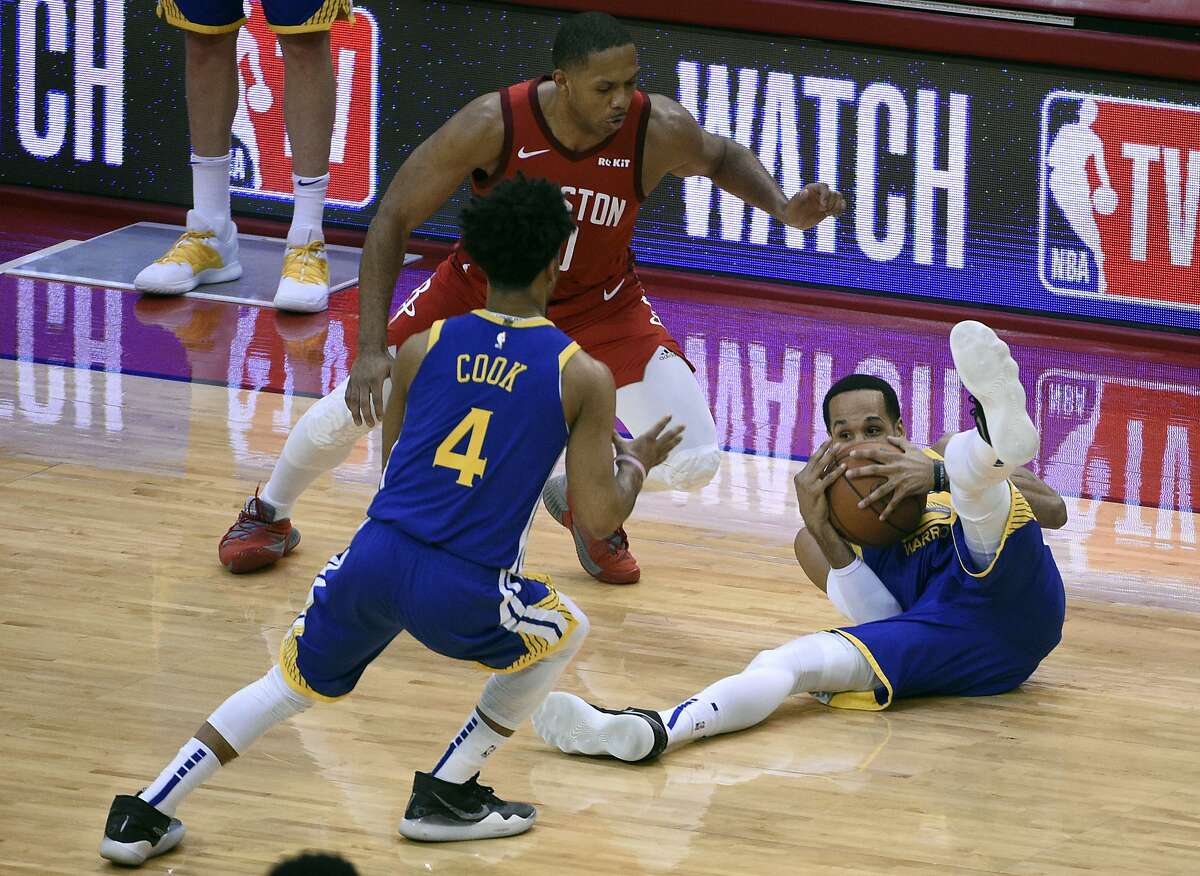 Golden State Warriors' Quinn Cook and Houston Rockets' Houston Rockets' Eric Gordon, rear, watch as the Warriors' Shaun Livingston, right, secures a loose ball on the floor during the second half of Game 6 of a second-round NBA basketball playoff series, Friday, May 10, 2019, in Houston. (AP Photo/Eric Christian Smith)