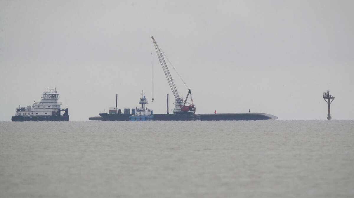 A capsized barge that was involved in a collision with the tanker ship Genesis River the day before remains in the Houston Ship Channel on Saturday, May 11, 2019, in Pasadena.