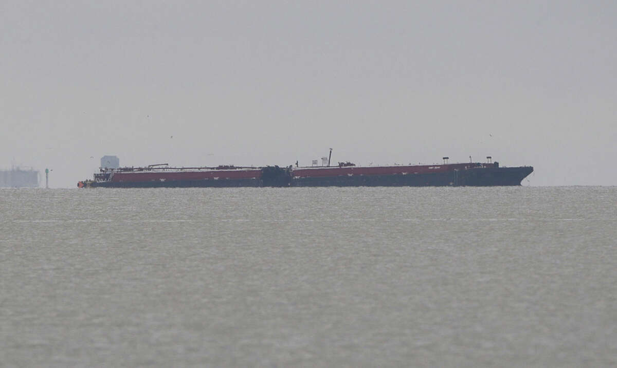 A barge that was involved in a collision with the tanker ship Genesis River the day before remains in the Houston Ship Channel on Saturday, May 11, 2019, in Pasadena.