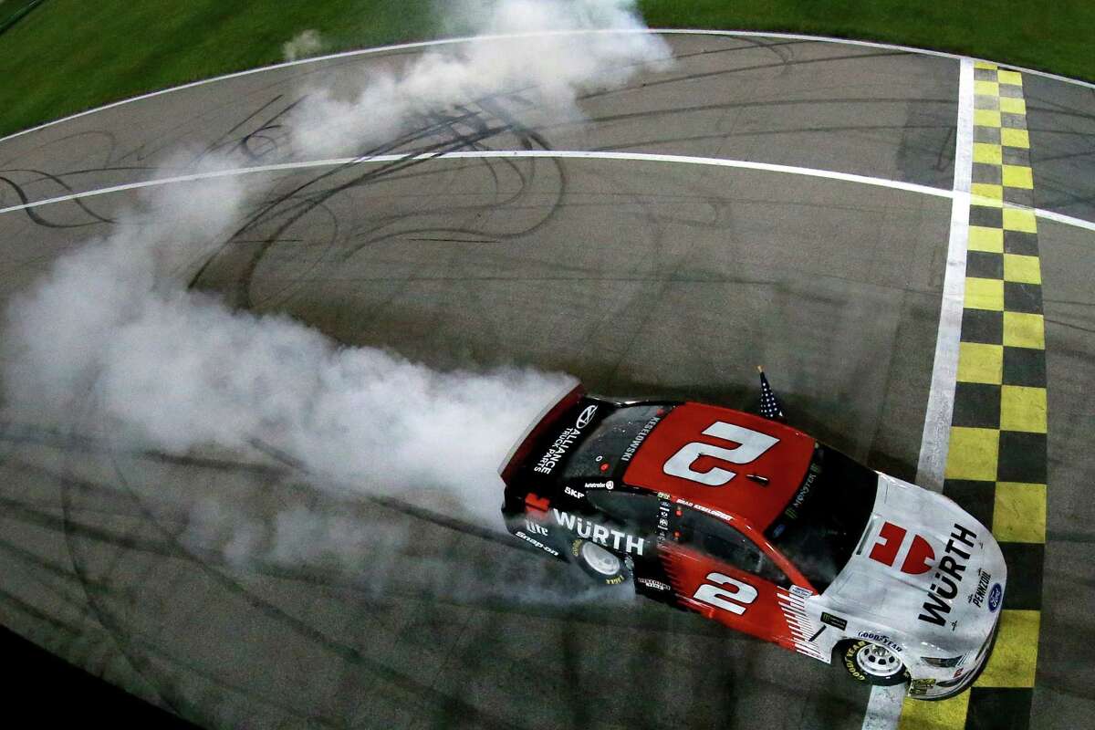 KANSAS CITY, KS - MAY 11: Brad Keselowski, driver of the #2 Wurth Ford, does a burn out after winning the Monster Energy NASCAR Cup Series Digital Ally 400 at Kansas Speedway on May 11, 2019 in Kansas City, Kansas. (Photo by Sean Gardner/Getty Images)