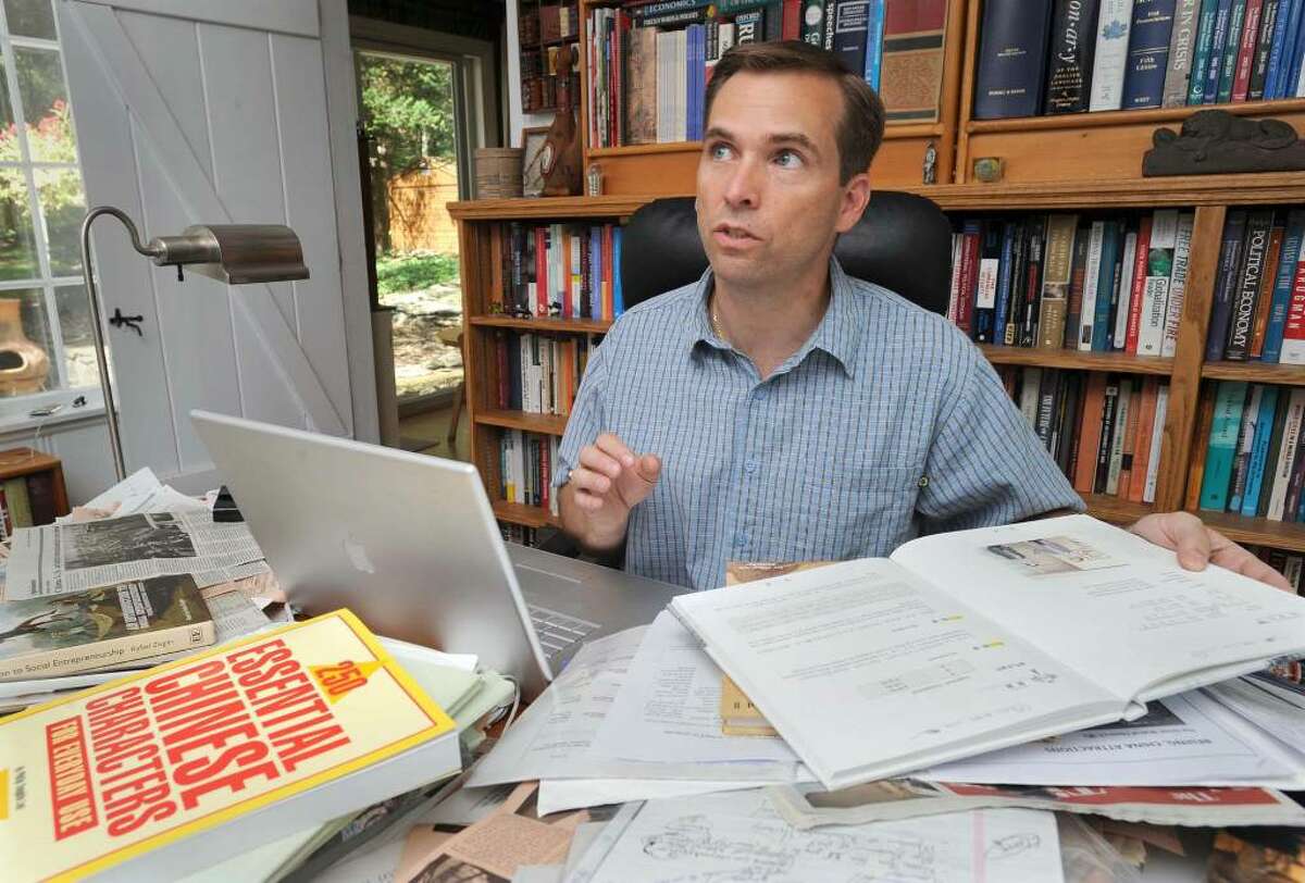 Chris Kukk of Brookfield, a WestConn professor who went to China recently to help the government devise policy papers for water conservation, is shown in his home office on Monday July 26, 2010.