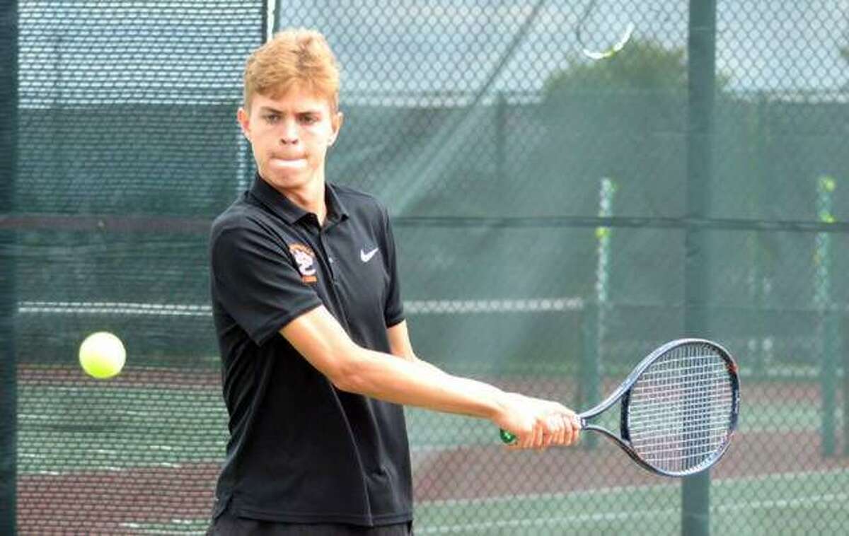 Edwardsville sophomore Ben Blake returns a shot during his No. 3 doubles match in the Southwestern Conference Tournament on Friday at Belleville West.