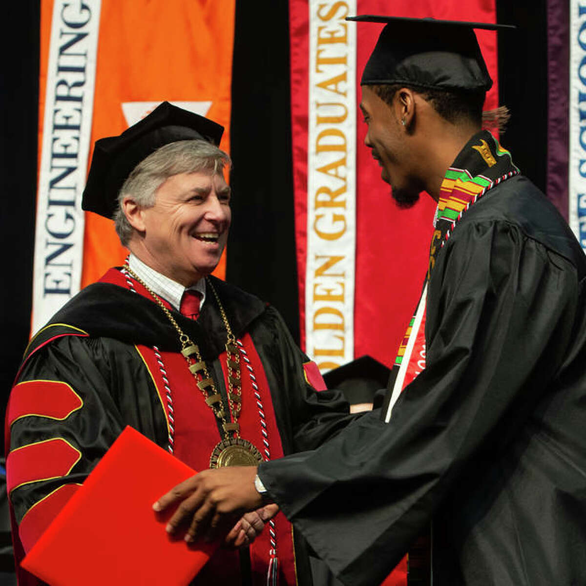 SIUE Chancellor Randy Pembrook congratulates Braxton McCarroll, president of SIUE Collegiate 100, at the 2019 Spring Commencement Ceremony for the School of Business.