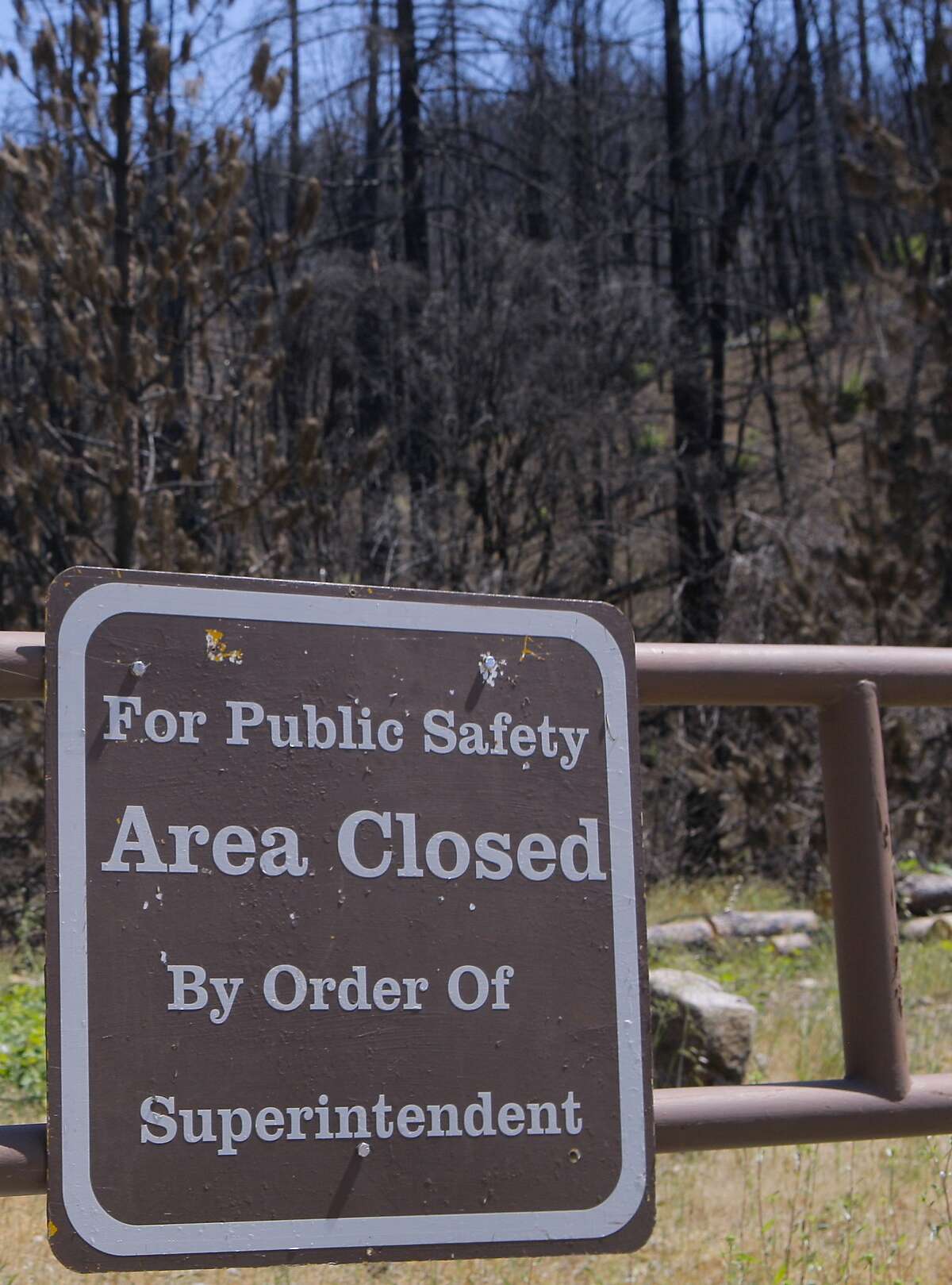 A locked gate bars visitors from an area burned by the Carr Fire at Whiskeytown National Recreation Area