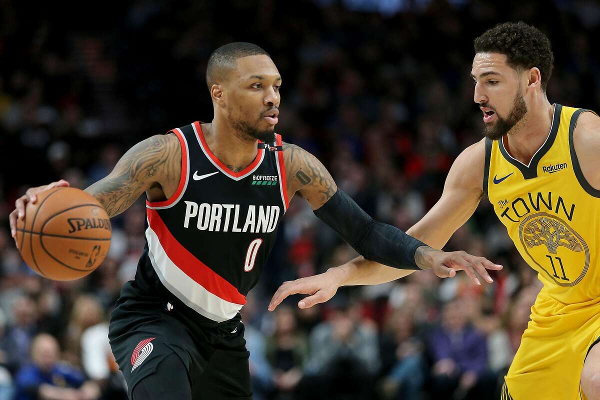PORTLAND, OR - FEBRUARY 13: Damian Lillard #0 of the Portland Trail Blazers dribbles against Klay Thompson #11 of the Golden State Warriors in the first half during their game at Moda Center on February 13, 2019 in Portland, Oregon. NOTE TO USER: User exp