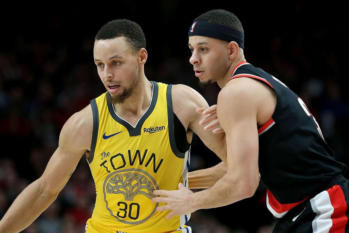 PORTLAND, OR - FEBRUARY 13: Stephen Curry #30 of the Golden State Warriors and Seth Curry #31 of the Portland Trail Blazers fight for the ball in the second half during their game at Moda Center on February 13, 2019 in Portland, Oregon. NOTE TO USER: Use