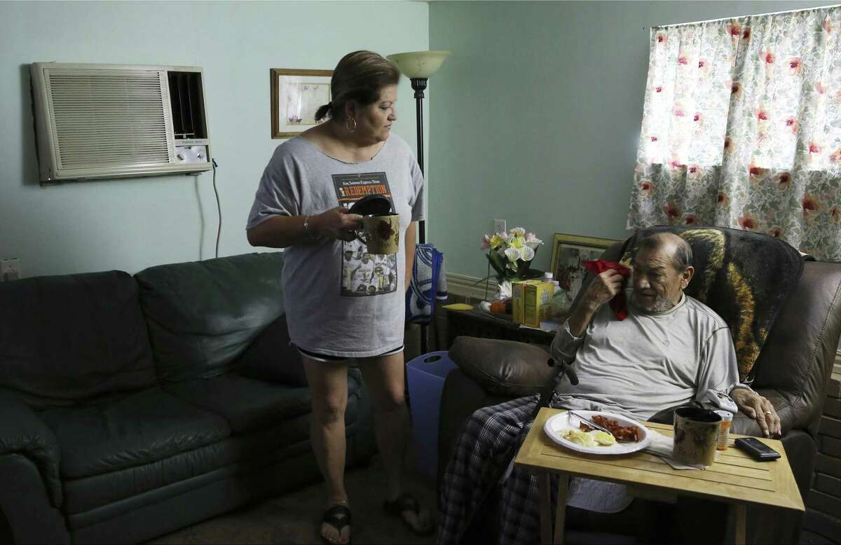 Susan Martinez serves breakfast to her husband, Alex Silva. Martinez does not have health insurance, and Silva is on hospice care. She faces a $7,406 hospital bill for a trip to the ER for walking pneumonia, but she’s not sure how she’ll pay.